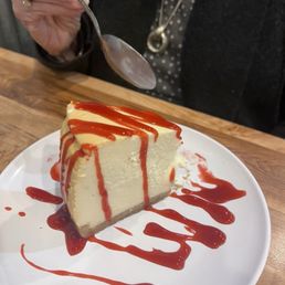 New York style Cheesecake w Raspberry sauce. New York style Cheesecake w Raspberry sauce.