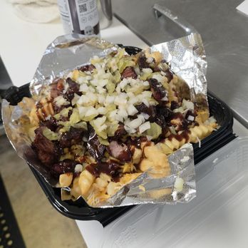 Flight Deck Grill - Dirty fries. A bed of fries with cheese, garlic butter, pulled pork, onions, pickles and BBQ Sauce. - Coffee & Tea Near Me - Redding, California