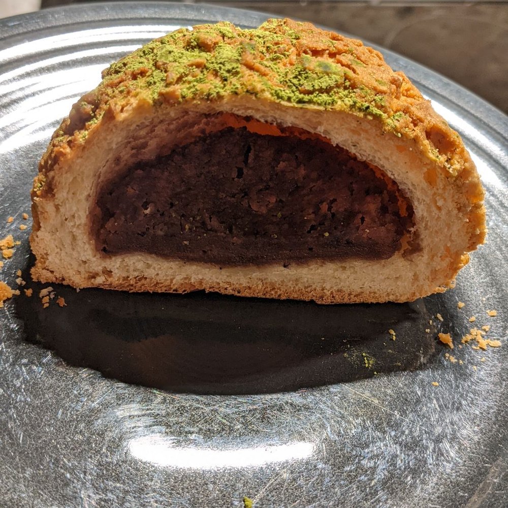 Norimoto Bakery - This is a pastry filled with red bean paste and topped with cookie crumble and matcha dust. - Bakeries Near Me - Portland, Maine Norimoto Bakery - This is a pastry filled with red bean paste and topped with cookie crumble and matcha dust. - Bakeries Near Me - Portland, Maine