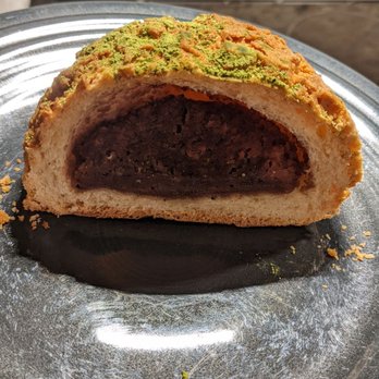 Norimoto Bakery - This is a pastry filled with red bean paste and topped with cookie crumble and matcha dust. - Bakeries Near Me - Portland, Maine Norimoto Bakery - This is a pastry filled with red bean paste and topped with cookie crumble and matcha dust. - Bakeries Near Me - Portland, Maine