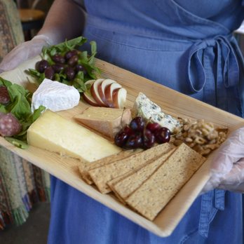 Picnic & Pantry - a woman holding a platter of cheese and crackers - Grocery Near Me - Somerville, Massachusetts Picnic & Pantry - a woman holding a platter of cheese and crackers - Grocery Near Me - Somerville, Massachusetts
