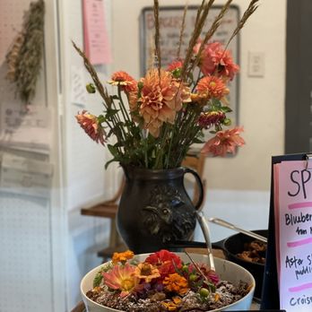 Asters Cafe and Bakery - a bowl of cereal and flowers on a table - Breakfast & Brunch Near Me - Marfa, Texas Asters Cafe and Bakery - a bowl of cereal and flowers on a table - Breakfast & Brunch Near Me - Marfa, Texas