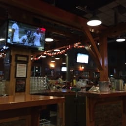 a bar with a television and people a bar with a television and people