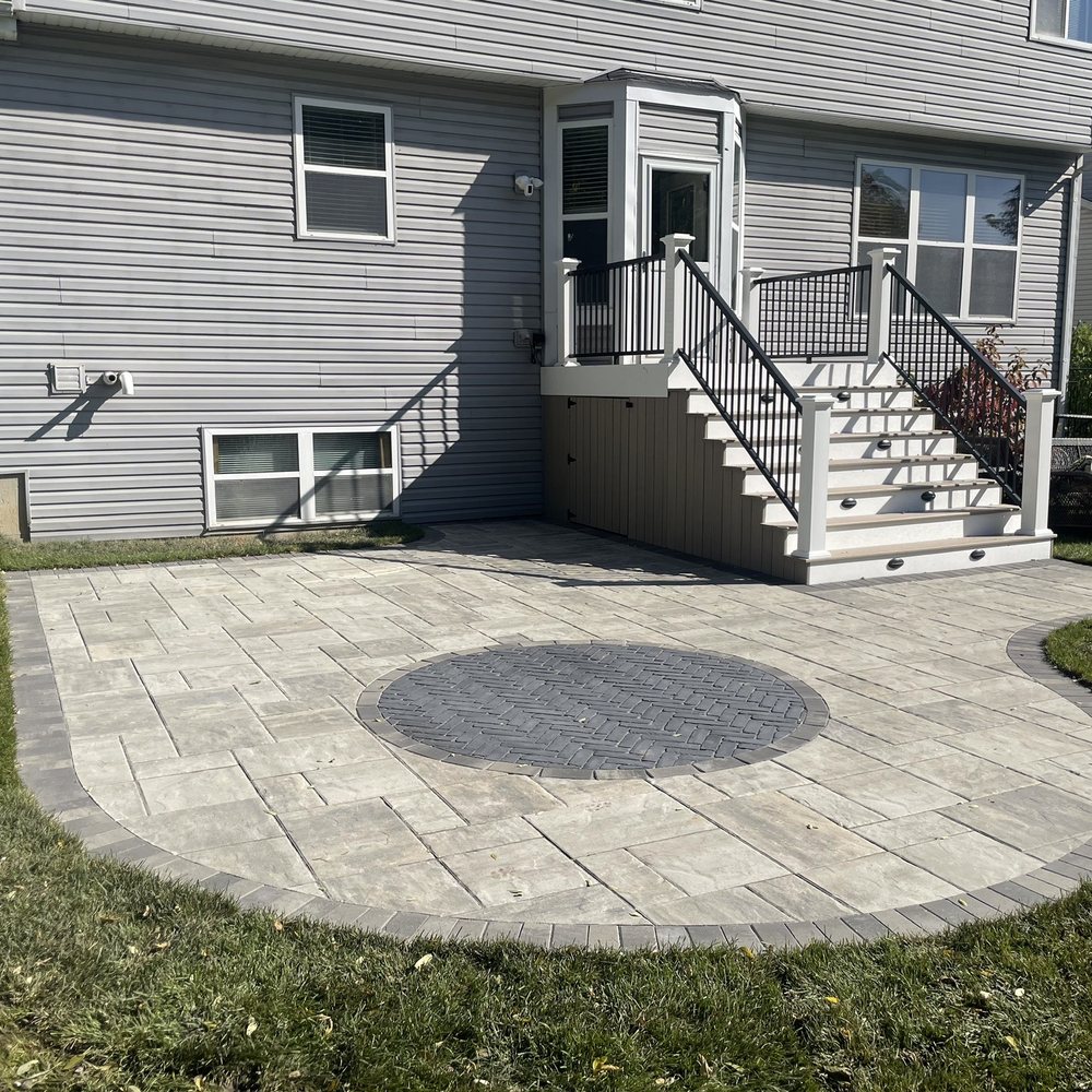 a patio with a circular paver a patio with a circular paver