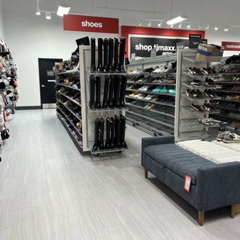 TJ Maxx - Shoes - Interior of a retail store featuring shoe shelves, accessory racks, and a seating area, with signage indicating shoe and restroom sections. - Department Stores Near Me - Winchester, Kentucky
