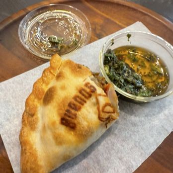 The Empanada's Box - The Buenos Aires empanada (half eaten) - Empanadas Near Me - Cincinnati, Ohio The Empanada's Box - The Buenos Aires empanada (half eaten) - Empanadas Near Me - Cincinnati, Ohio