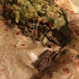 a tortilla with meat and guacamole a tortilla with meat and guacamole