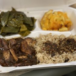 Momma Luv’s Soul & Carribean Food - Caribbean jerk chicken plate with rice, beans, and two sides.