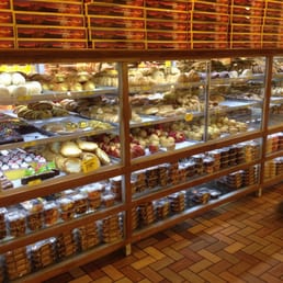 a man walking past a display of baked goods