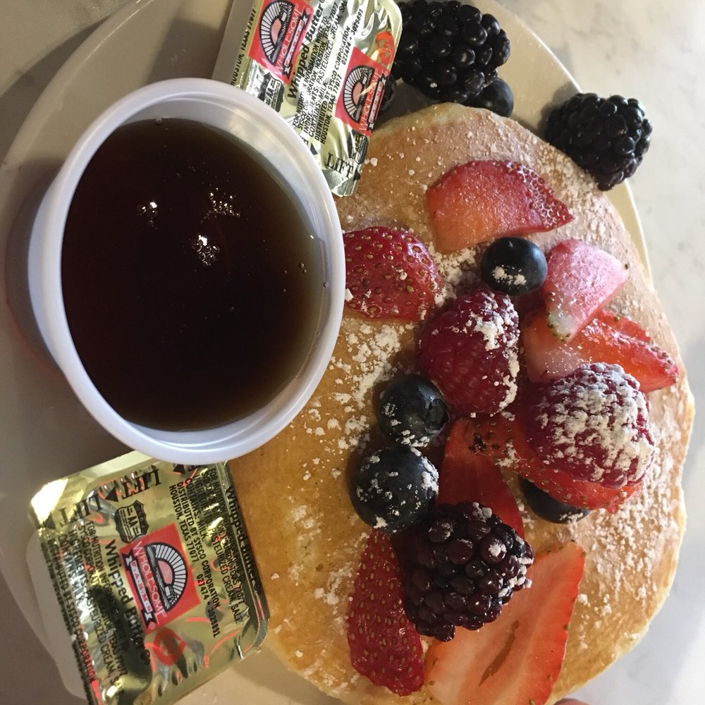 Eggsellent Cafe - Side of pancakes topped with Fresh Fruit - Breakfast & Brunch Near Me - Frisco, Texas