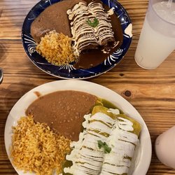 Casa Jacaranda - Cocina Mexicana - Blue plate: Chicken Mole enchiladas  White plate: Chicken Green salsa w/t crema enchiladas