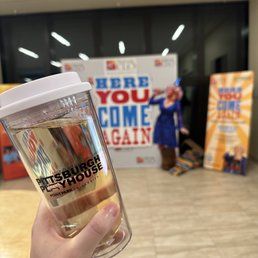 My spill proof glass of Pinot Grigio and the 'Here You Come Again' backdrop
