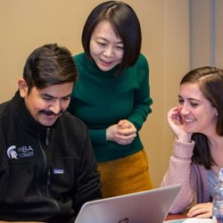 Eli Broad College of Business - Two broad College of Business MBA students receiving personal instruction from their professor.