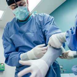 Sean T. Lille, MD - Dr. Lille putting on sterile gloves for surgery.