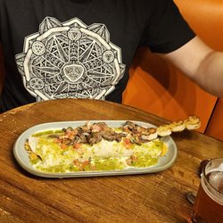 Mariscos Nayarit - Shrimp/steak burrito, odd presentation. Inside was veggie, so shrimp and steak more like toppings. Note awkward booth shape/table distance.