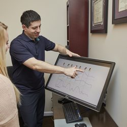 Genesis Chiropractic Clinic - going over exam results