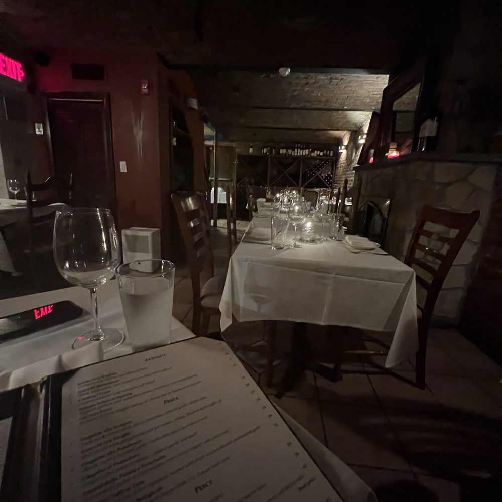 Ristorante Euno - a table with a menu and wine glasses - Italian Near Me - Boston, Massachusetts Ristorante Euno - a table with a menu and wine glasses - Italian Near Me - Boston, Massachusetts
