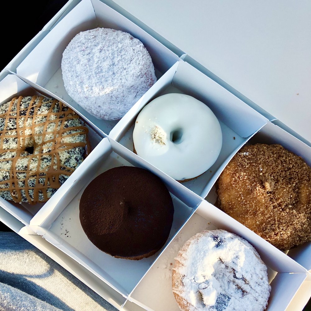 Beacon Doughnuts - Top: blackberry, blueberry lavender, spiced pumpkin
Bottom: caramel chocolate crunch, boston cream, blueberry pancake - Donuts Near Me - Chicago, Illinois Beacon Doughnuts - Top: blackberry, blueberry lavender, spiced pumpkin
Bottom: caramel chocolate crunch, boston cream, blueberry pancake - Donuts Near Me - Chicago, Illinois