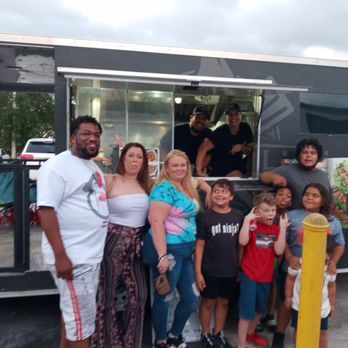 GIMME GRILLIN - a group of people standing in front of a food truck - Food Trucks Near Me