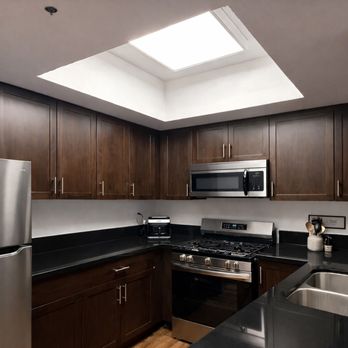 The Shiny Crew - Wood cabinetry and surfaces carefully cleaned and maintained for a calm, polished kitchen. - Home Cleaning Near Me - Los Angeles, California