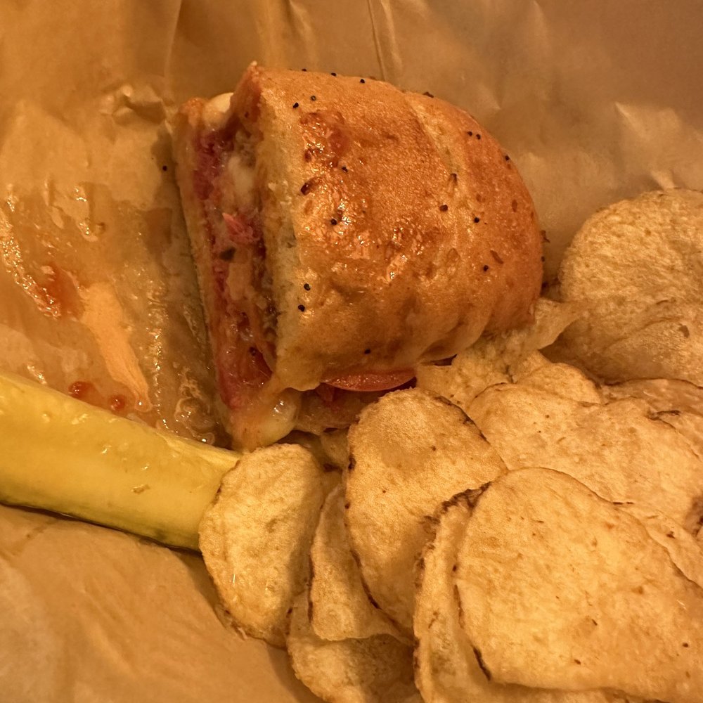The Yellow Deli - Half of my sandwich, kettle chips and pickle. Delish - Desserts Near Me - Ithaca, New York