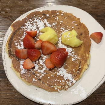 First Watch - Lemon Ricotta Pancake with Strawberries, Lemon Curd, and Powdered Sugar - Breakfast & Brunch Near Me - Kansas City, Missouri