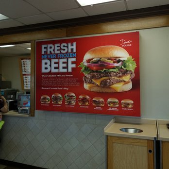 Wendy's - a woman standing in front of a large poster - Burgers Near Me - Woodstock, Virginia Wendy's - a woman standing in front of a large poster - Burgers Near Me - Woodstock, Virginia