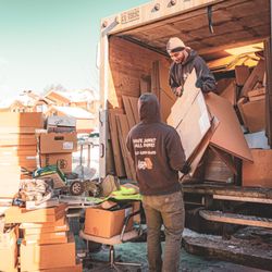 Dunk Disposal - Our junk removal service in action. Moving out boxes, electronics, tools from a garage clearout.