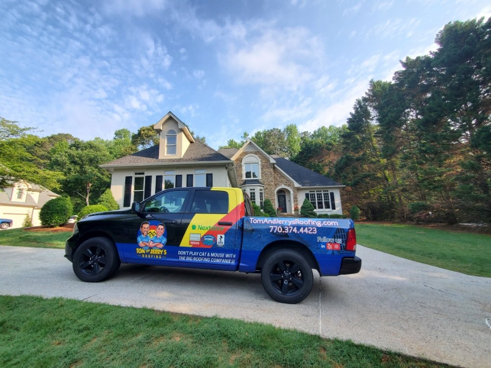 Slide of Tom and Jerry's Roofing