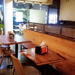 Inside dining area. Nice sleek hardwood tables and benches and plastic chairs. Inside dining area. Nice sleek hardwood tables and benches and plastic chairs.