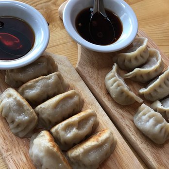 Fortune Wok to Table - Left to right: fried pork dumplings with mild sauce, steamed beef dumplings with hot sauce. - Noodles Near Me - Denver, Colorado