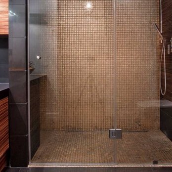 Emilco Construction - a modern bathroom with a glass shower - General Contractors Near Me Emilco Construction - a modern bathroom with a glass shower - General Contractors Near Me