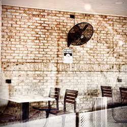 Super cute covered outdoor cafe area with fans! OuiOui.