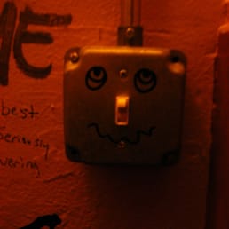 a light switch with a face drawn on it a light switch with a face drawn on it