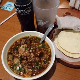 Goat stew $13.95 with my $3.49 Mexican Coke.  4 handmade flour tortillas.  Goat pieces very tender and delicious .