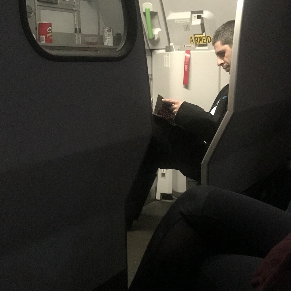 Frontier Airlines - Flight crew reading while other getting water as that is all offered to passengers. - Airlines Near Me - Milwaukee, Wisconsin