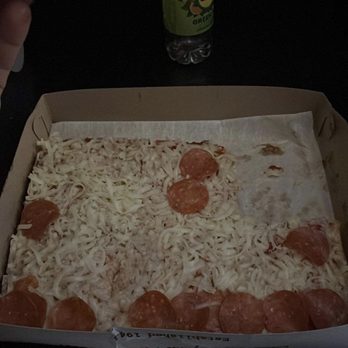 Dicarlos Pizza - Highlands - a person taking a slice of pizza - Pizza Near Me - Triadelphia, West Virginia