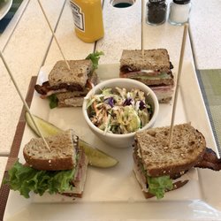 Eagles - Club sandwich (turkey, ham, cheese, mayo, and bacon) on homemade multigrain bread with coleslaw.