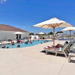 Southern Oaks RV Resort - Guests enjoying our brand-new 12.5' x 12.5' spa and newly renovated heated saltwater swimming pool