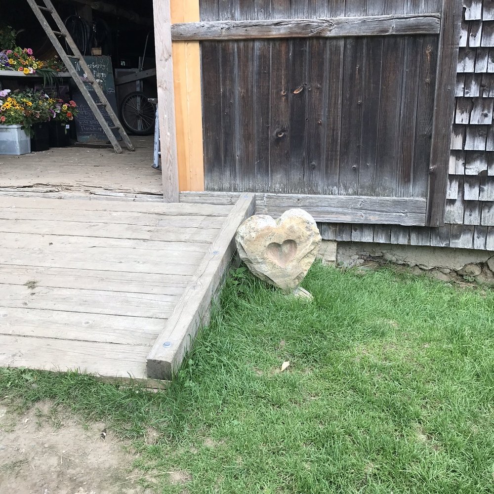 a barn with a wooden door and steps a barn with a wooden door and steps