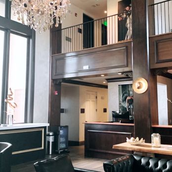 The London Club - a living room with high ceilings and a chandelier - Cocktail Bars Near Me - Naples, Florida