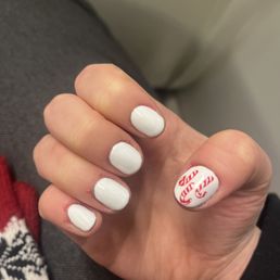 White gel nails with candy cane design on thumb White gel nails with candy cane design on thumb