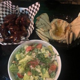 a bowl of salad and pita chips