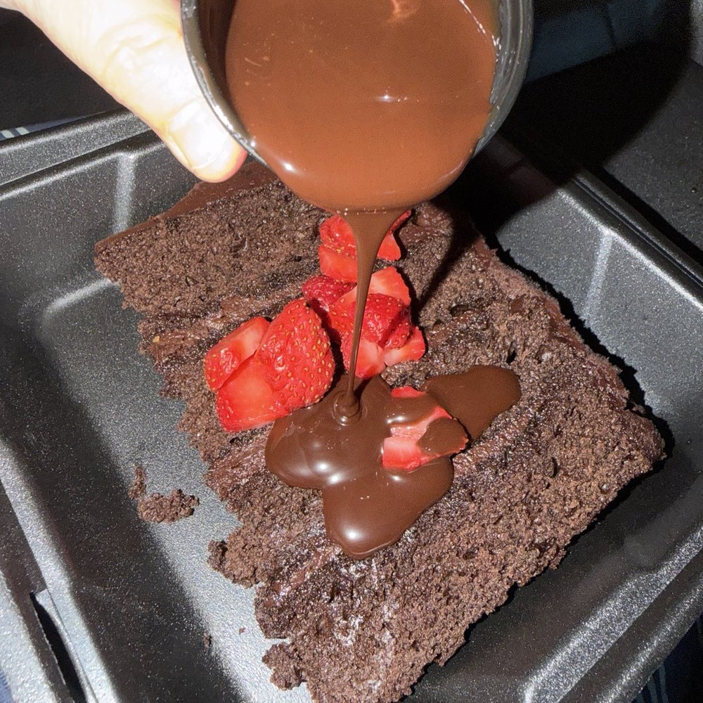 Caracu - Tall chocolate cake that I hot to go had strawberries  on the side and chocolate syrup! So delicious - Steakhouses Near Me - Nogales, Arizona