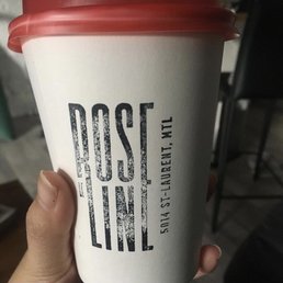 a hand holding a cup of coffee a hand holding a cup of coffee