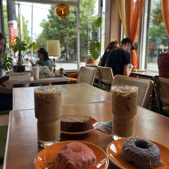Wallflower Coffee - Two iced lattes, a matcha strawberry scone, poppy seed loaf, and chocolate earl grey donut - Coffee & Tea Near Me - Portland, Oregon Wallflower Coffee - Two iced lattes, a matcha strawberry scone, poppy seed loaf, and chocolate earl grey donut - Coffee & Tea Near Me - Portland, Oregon