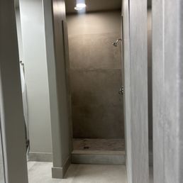 Shower with no towel hook, no curtain for privacy, and nowhere to put your own shower products except the floor. Shower with no towel hook, no curtain for privacy, and nowhere to put your own shower products except the floor.