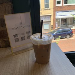 Cartwright Food Hall - Iced latte with oat milk, mocha, and caramel syrup. Over looking trade street from the second story seating area.