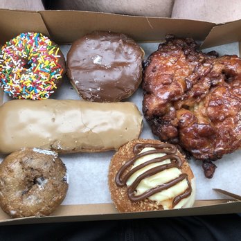Delicious Donuts - CW from top left: choc cake w/ sprinkles, Boston cream, apple fritter, cream special, blueberry, maple log - Donuts Near Me - Portland, Oregon Delicious Donuts - CW from top left: choc cake w/ sprinkles, Boston cream, apple fritter, cream special, blueberry, maple log - Donuts Near Me - Portland, Oregon