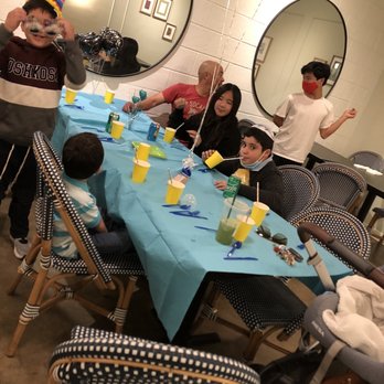 Nosh House by OC Kosher - a group of people sitting around a table - Delis Near Me - Tustin, California